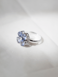 Anel trevo em ouro branco 18k com iolitas e brilhante central